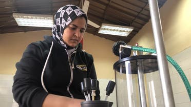 Lekaa El Kholy, Egypt’s first female mechanic, checks auto engine oil changer at her new maintenance center in Luxor city on January 2, 2020. (Reuters)