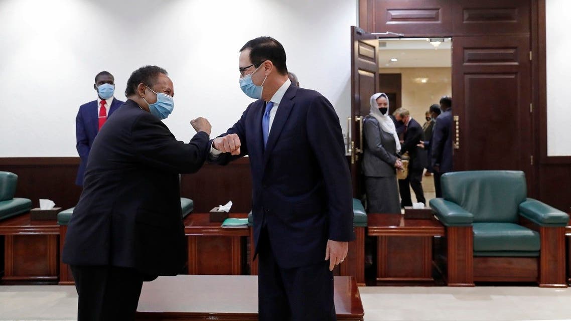 Sudanese Prime Minister Abdullah Hamdok (left), elbow bumps as he welcomes US Treasury Secretary Steven Mnuchin to the Cabinet Building, in Khartoum, Sudan, on January 6, 2021. (AP)26