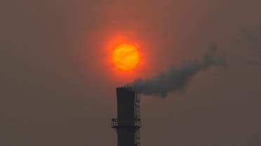 FILE- Smoke billows from a chimney of a heating plant as the sun sets in Beijing in this file photo dated Monday, Feb. 13, 2012. U.N. climate talks being held in Bonn, Germany, are in gridlock Thursday May 24, 2012, as a rift between rich and poor countries risked undoing some of the advances made last year in the two-decade-long effort to control carbon emissions from fast-growing economies like China and India as well as developed industrialized nations that scientists say are overheating the planet.(AP Photo/Alexander F. Yuan, File)