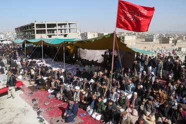 People offer prayers beside a tent with the bodies of coal miners from Pakistan's minority Shi'ite Hazara community, who were killed in Mach area of Bolan district, as they protest demanding justice, in Quetta, Pakistan January 5, 2021. (Reuters)