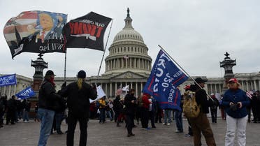 Supporters of US President Donald Trump hold a rally outside the US Capitol as they protest the upcoming electoral college certification of Joe Biden as US President in Washington, DC . (AFP)