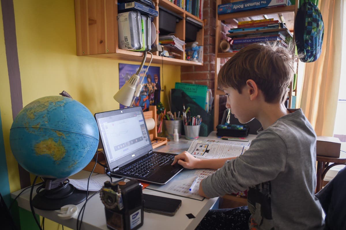 Kamen, 9, attends an online class at his home on November 30, 2020 in Sofia, Bulgaria, as schools close amidst lockdown restrictions to curb the spread of the new coronavirus pandemic. (Nikolay Doychinov/AFP)