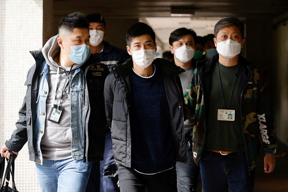 Pro-democracy activist Lester Shum is taken away by police officers after over 50 Hong Kong activists arrested under security law as crackdown intensifies, in Hong Kong, China, on January 6, 2021. (Reuters)