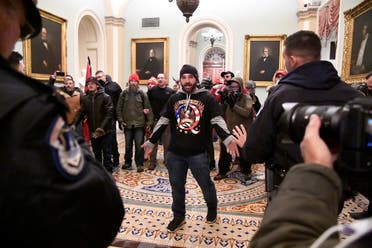 A supporter of President Donald Trump confronts police as Trump supporters demonstrate on the second floor of the U.S. Capitol near the entrance to the Senate after breaching security defenses, in Washington, U.S., January 6, 2021. (Reuters)