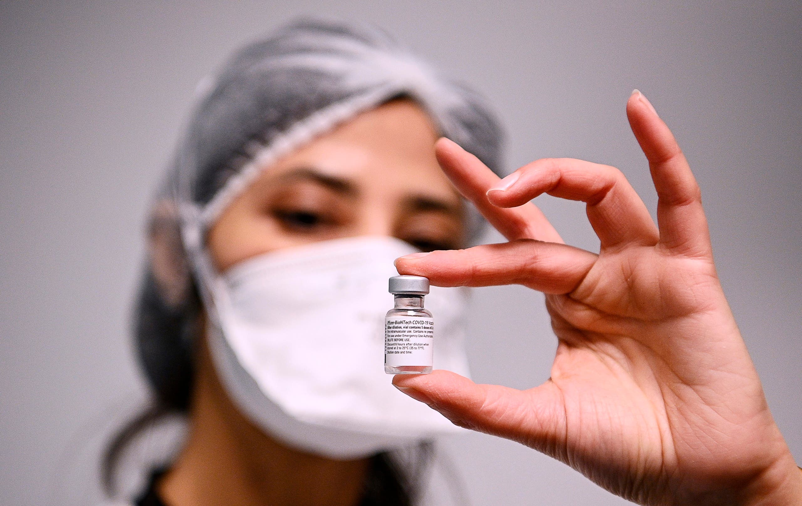 A health worker displays a dose of the Pfizer-BioNTech COVID-19 vaccine at Robert Ballanger hospita in Aulnay-sous-Bois, north of Paris. (AP)