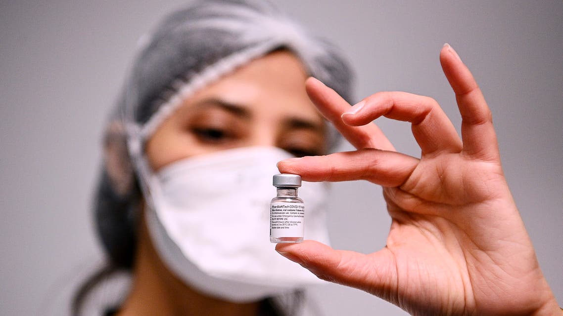 A health worker displays a dose of the Pfizer-BioNTech COVID-19 vaccine at Robert Ballanger hospita in Aulnay-sous-Bois, north of Paris, Wednesday, Jan.6, 2021. Amid public outcry, France's health minister promised Tuesday an exponential acceleration of his country's shockingly slow coronavirus vaccination process. (Christophe Archambault/Pool Photo via AP)