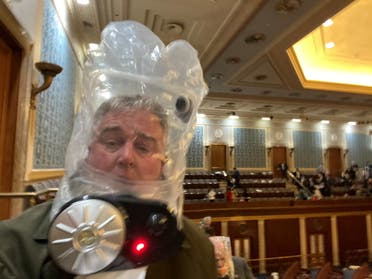 Rep. David Trone wears a gas mask inside the U.S. Capitol in Washington, DC, U.S., January 6, 2021, in this still image obtained from social media. (Reuters)