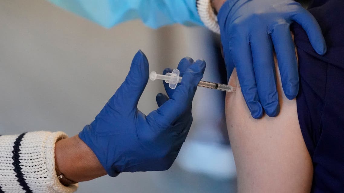 A healthcare worker is inoculated with the COVID-19 vaccine, Wednesday, Jan. 6, 2021, at John Knox Village in Pompano Beach, Fla. Ninety residents and 80 staff members received their second shot of the vaccine Wednesday and 50 new staff members received their first round of the vaccine. (AP Photo/Wilfredo Lee)