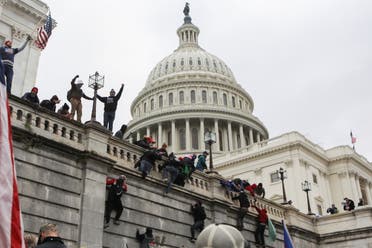 Supporters of US President Donald Trump climb on walls at the US Capitol on January 6, 2021. (Reuters)