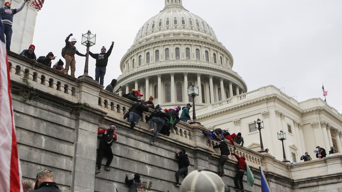 Supporters of US President Donald Trump climb on walls at the U.S Capitol during a protest against the certification of the 2020 US presidential election results by the US Congress, in Washington, US, January 6, 2021. (Reuters)
