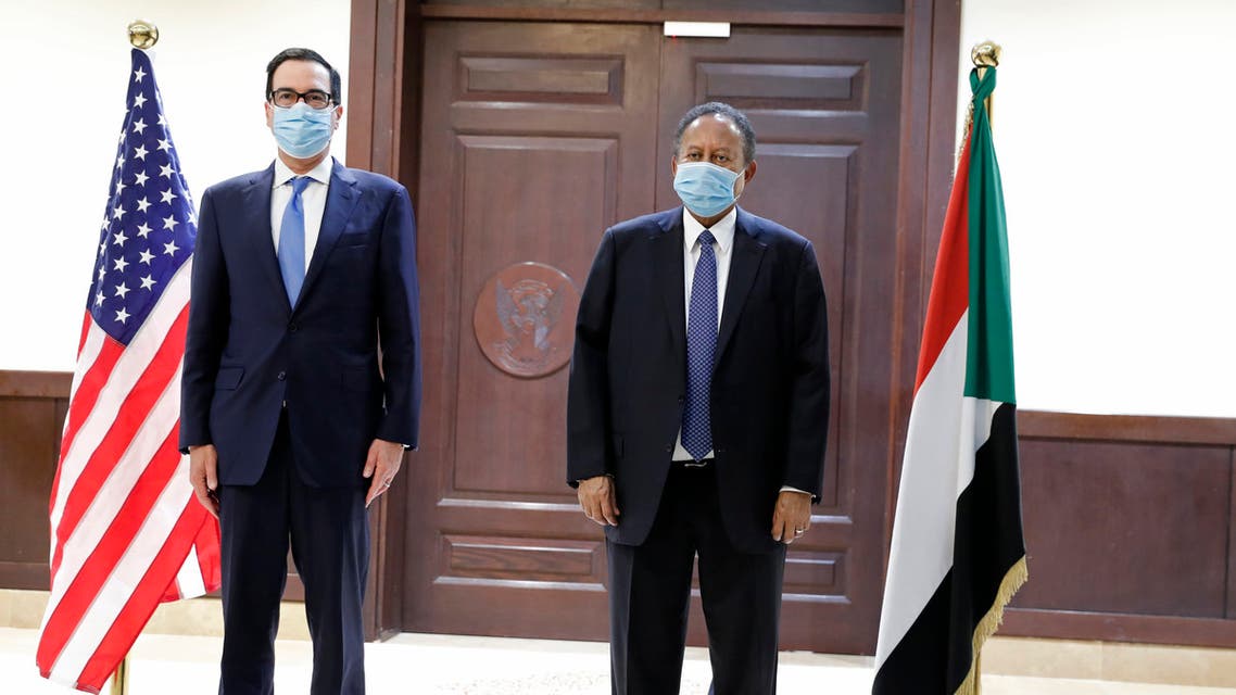 Sudanese Prime Minister Abdullah Hamdok, right, welcomes US Treasury Secretary Steven Mnuchin to the Cabinet Building, in Khartoum, Sudan, Wednesday, Jan. 6, 2021. (AP)