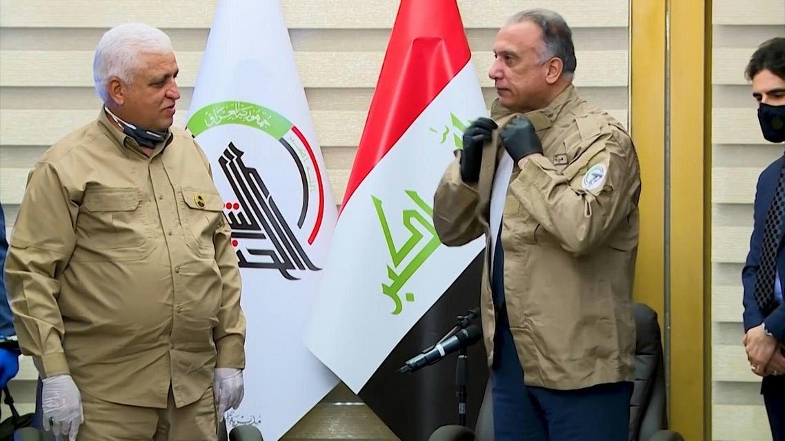 Iraq's Prime Minister Mustafa Kadhemi wears the uniform of the Hashed al-Shaabi during a meeting with Faleh Fayyadh, (File photo: AFP)