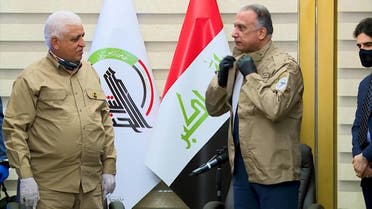 Iraq's Prime Minister Mustafa Kadhemi wears the uniform of the Hashed al-Shaabi during a meeting with Faleh Fayyadh, (File photo: AFP)