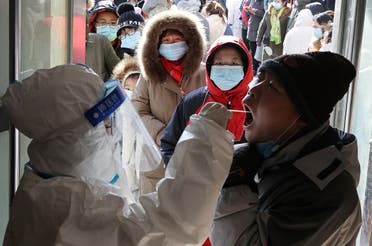 A medical worker in protective suit collects a swab from a resident during a mass nucleic acid testing following a recent coronavirus disease (COVID-19) outbreak in Shijiazhuang, Hebei province, China. (Reuters)