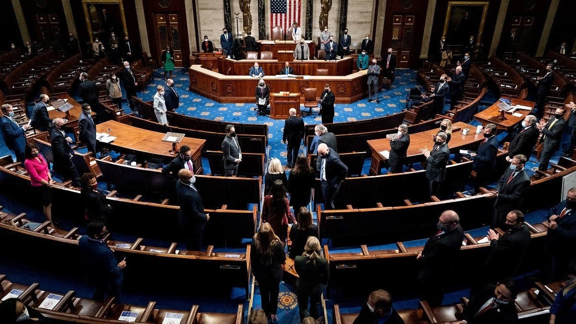 Electoral college votes are brought in before House Speaker Nancy Pelosi and Vice President Mike Pence resume presiding over a Joint session of Congress to certify the 2020 Electoral College results, after supporters of President Donald Trump stormed the Capitol earlier in the day, on Capitol Hill in Washington, US, on January 6, 2021. (Reuters)