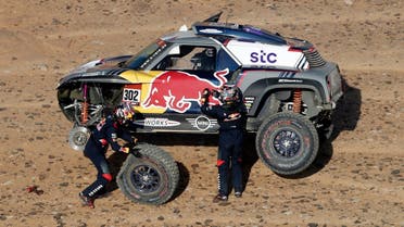 X-Raid Mini JCW Team's Stephane Peterhansel and Co-Driver Edouard Boulanger attend to their car during stage 3. (Reuters)