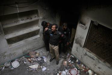 Pakistani police officers examine the house of a family belonging to the Ahmadi sect, which was torched by angry mob following rumors about blasphemous postings on Facebook, in Gujranwala, Pakistan. (AP)