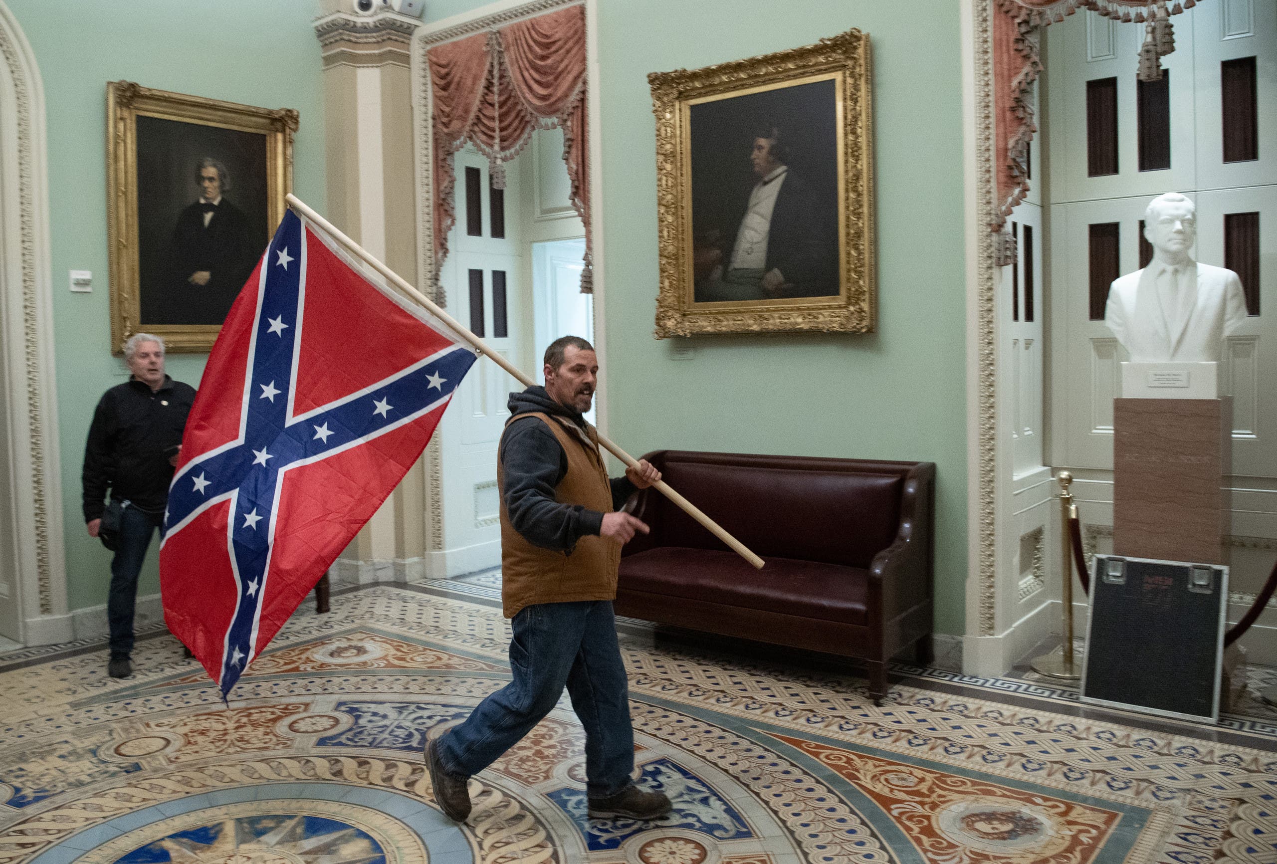 A protester holds a federal flag in the Congress building (Archive France Press)