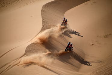 Australian biker Toby Price (top) and Argentinian biker Kevin Benavides compete during Stage 4 of the Dakar Rally 2021 between Wadi Ad-Dawasir and Saudi Arabia's capital Riyadh, on January 6, 2021. (AFP)