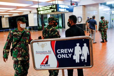 Indonesian soldiers are seen at Soekarno-Hatta International Airport after Sriwijaya Air plane flight SJ182 with more than 50 people on board lost contact. (Reuters) 