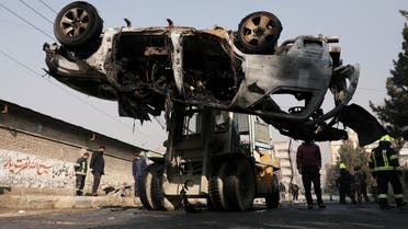 Afghan officials transport the wreckage of a burnt car at the site of a bomb blast in Kabul, Afghanistan January 10, 2021. (Reuters/Omar Sobhani)