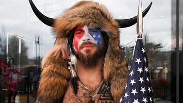 Jacob Anthony Chansley, also known as Jake Angeli, of Arizona, poses with his face painted in the colors of the US flag. (Reuters)