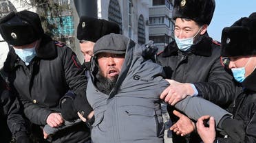 A protester is taken away by law enforcement officers during a rally held by opposition supporters on the parliamentary election day in Almaty, Kazakhstan January 10, 2021. (Reuters)