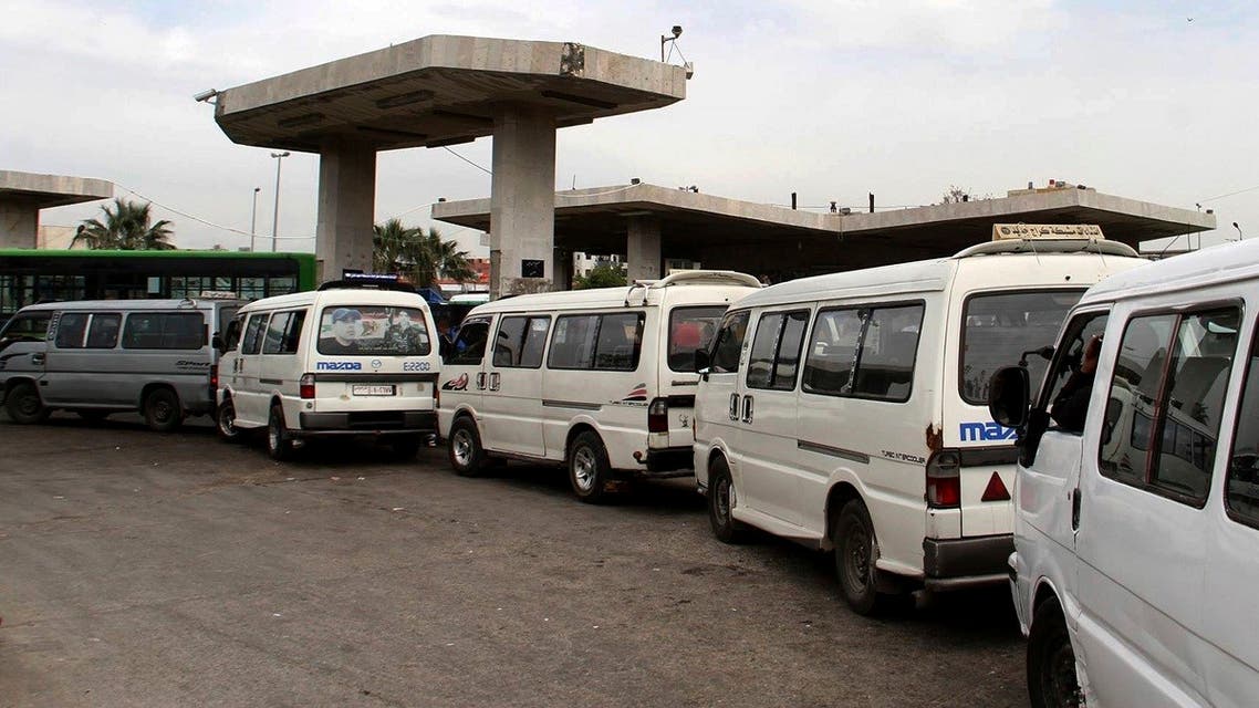 In this file photo released on April 7, 2019, by the Syrian official news agency SANA, shows vans queuing to fill their tanks with fuel, at a gas station in Daraa, south Syria. (SANA via AP)
