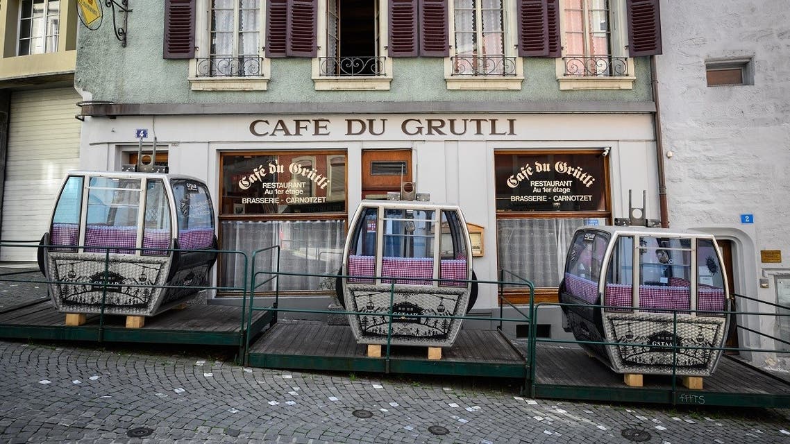 Ski gondolas used as sidewalk cafe pods are seen in front of a closed restaurant amid the spread of the COVID-19 caused by the novel coronavirus, in Lausanne on March 21, 2020. (Fabrice Coffrini/AFP)
