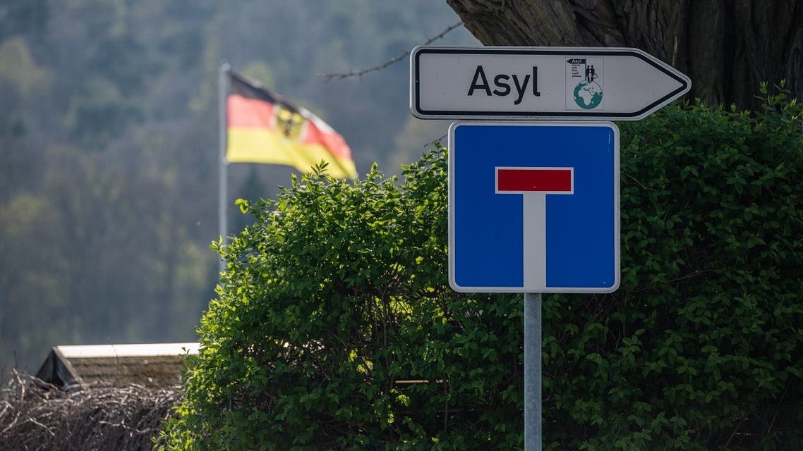 A traffic sign saying ‘Asylum’ and a one way street sign hang near the central contact point for asylum seekers (ZASt) in the state of Saxony-Anhalt on April 8, 2020, in Halberstadt, eastern Germany. (Jens Schlueter/AFP)
