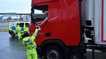 A police officer checks a driver's Covid-19 test documentation at the entrance to the Port of Dover, southeast England, on January 4, 2021 following Britain's departure from the European Union. (Glyn KIRK/AFP)