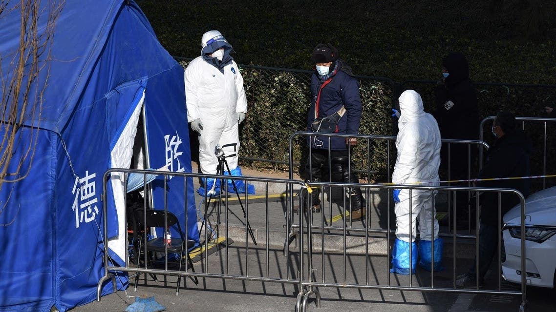 Health workers direct residents as they line up to be tested for the coronavirus in Beijing on January 11, 2021. (Greg Baker/AFP)