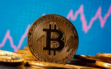 A representation of virtual currency Bitcoin is seen in front of a stock graph in this illustration taken November 19, 2020. (Reuters)
