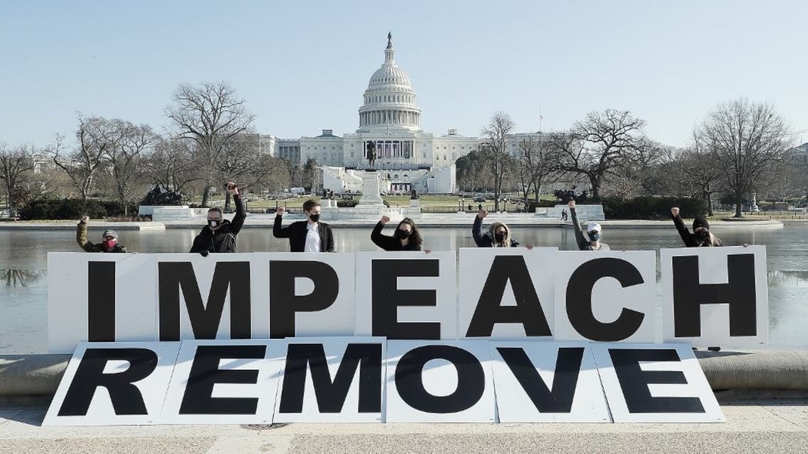 People gather at the base of the U.S. Capitol with large IMPEACH and REMOVE letters on January 12, 2021 in Washington, DC. (AFP)