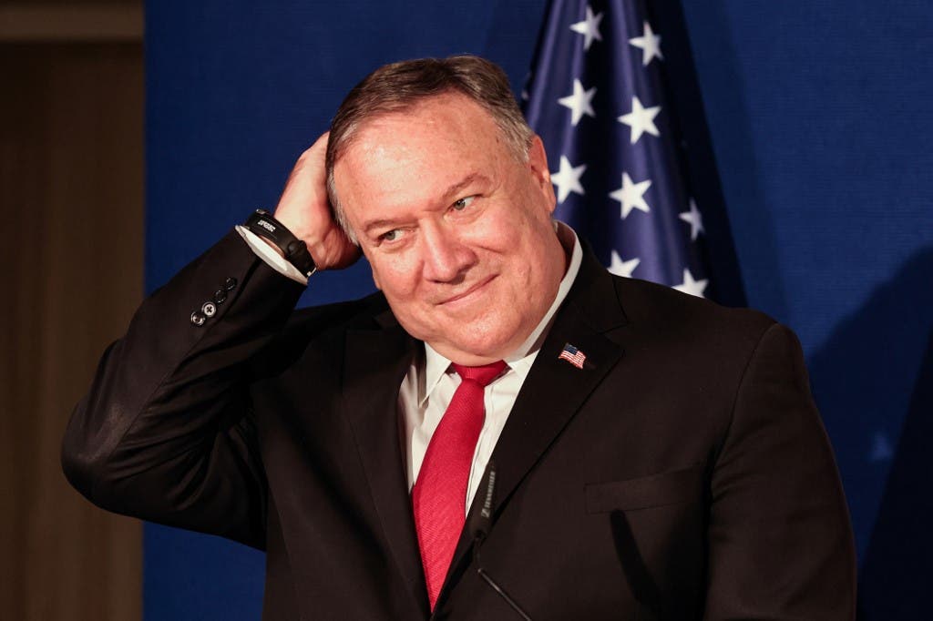 US Secretary of State Mike Pompeo pats his head during a press conference. (AFP)