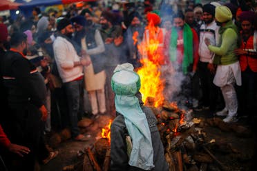 Farmers burn farm law copies in a bonfire as they celebrate the Lohri festival, at the site of a protest against the new farm laws, at the Delhi-Uttar Pradesh border in Ghaziabad, India January 13, 2021. (Reuters)