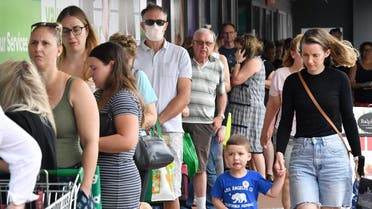 Shoppers queue to enter a grocery store before lockdown measures are imposed to curb the spread of the Coronavirus in Brisbane, the capital of the Australian state of Queensland, on Friday. (Reuters)