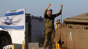 An Israeli soldier gestures as he stands atop an armoured personnel carrier during a military drill in the Israeli-annexed Golan Heights, on December 30, 2020. (AFP)