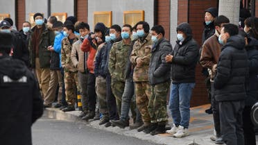 Workers line up outside a community centre to be vaccinated against the COVID-19 coronavirus in Beijing on January 12, 2021. (AFP)