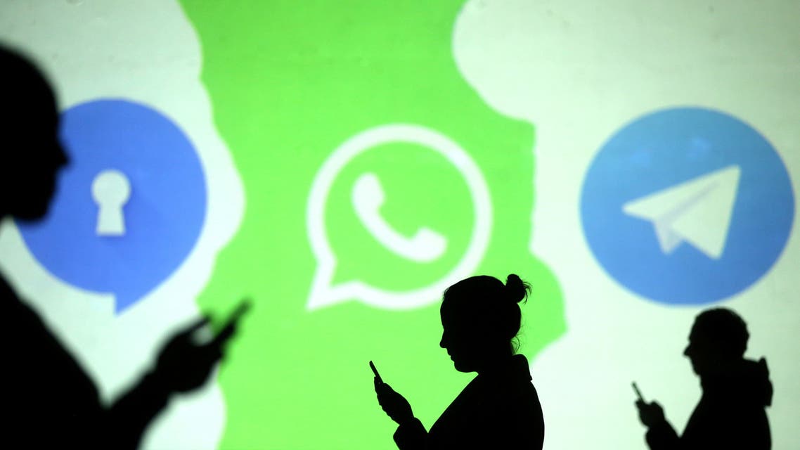 Silhouettes of mobile users are seen next to logos of social media apps Signal, Whatsapp and Telegram projected on a screen in this picture illustration taken March 28, 2018. REUTERS/Dado Ruvic/Illustration