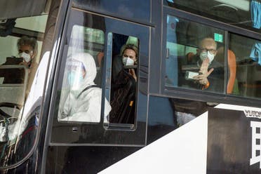 WHO team sit on a bus while leaving Wuhan Tianhe International Airport in Wuhan, Hubei province, China, January 14, 2021. (Reuters)
