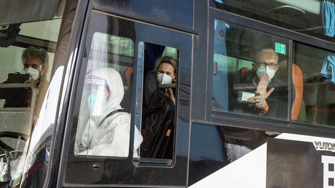 Members of the World Health Organisation (WHO) team tasked with investigating the origins of the coronavirus disease (COVID-19) pandemic sit on a bus while leaving Wuhan Tianhe International Airport in Wuhan, Hubei province, China, on January 14, 2021. (Reuters)_1068089859_RC2H7L9WN4UA_RTRMADP_3_HEALTH-CORONAVIRUS-WHO-CHINA