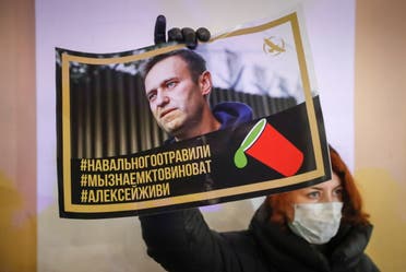 An activist holds a portrait of opposition politician Alexei Navalny during a picket in his support in St Petersburg, Russia December 22, 2020. (Reuters)