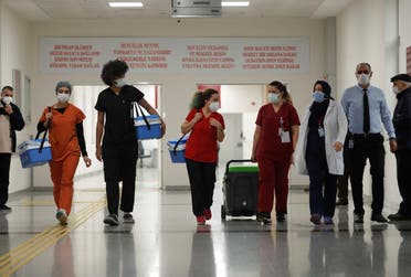 Health workers carry Sinovac's CoronaVac COVID-19 vaccine boxes at Sancaktepe Sehit Dr. Ilhan Varank Training and Research Hospital, in Istanbul, Turkey January 14, 2021. (Reuters)