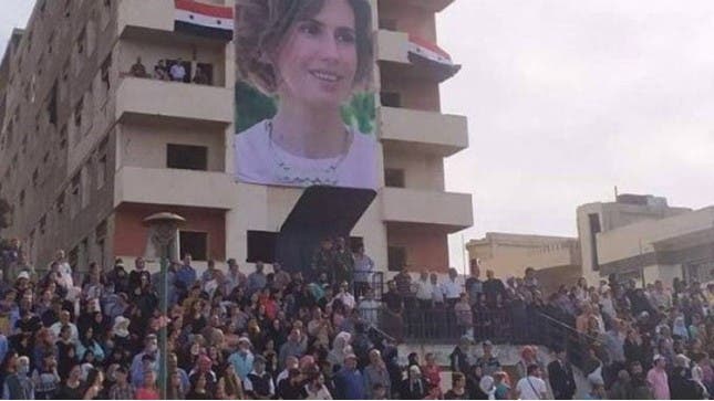 An image of Asma al-Assad hung from three floors of a sports field in the Baba Amr district of Homs