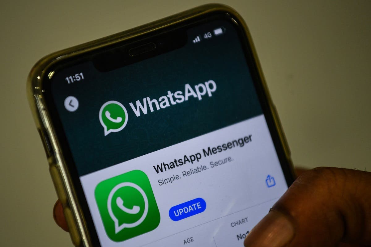 A user updates Facebook's WhatsApp application on his mobile phone in Mumbai. (AFP)
