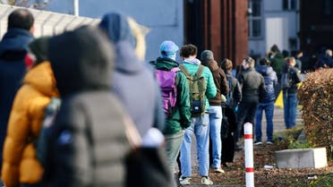 People queue at a walk-in COVID-19 testing centre at Wilhelmstrasse, amid the coronavirus disease (COVID-19) pandemic, in Berlin, Germany. (Reuters)