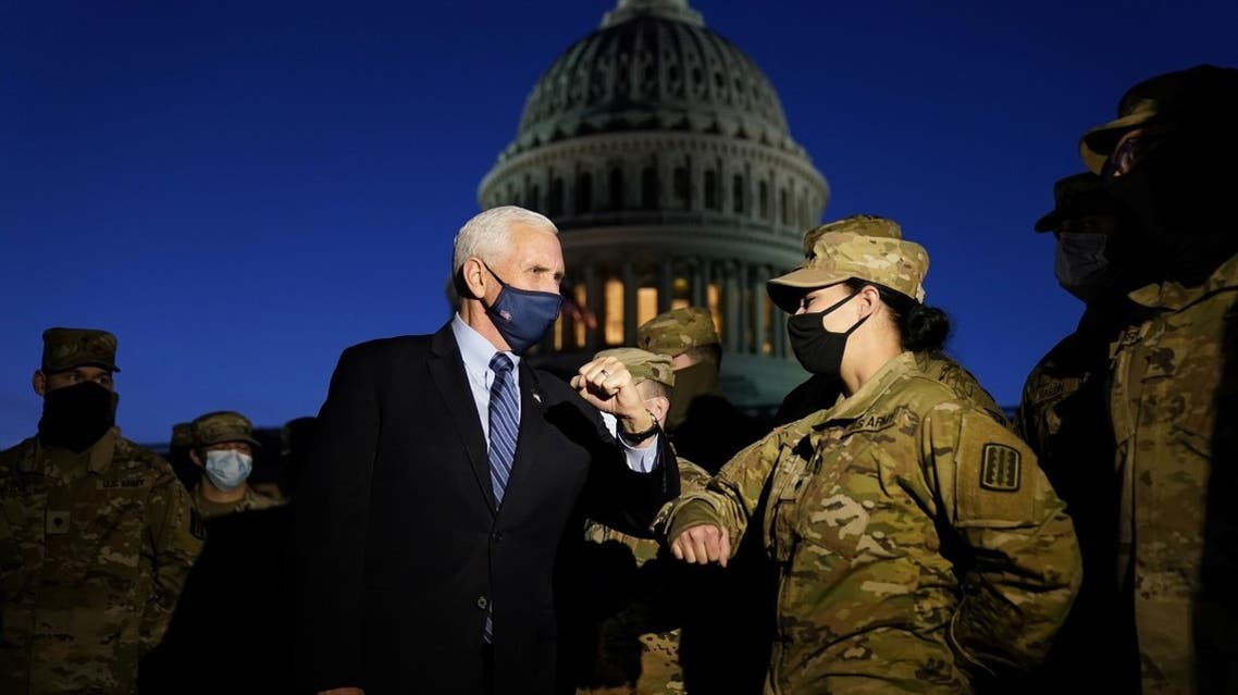 VP Mike Pence elbow bumps with a member of the National Guard as he speaks to troops outside the Capitol, January 14, 2021. (Reuters)