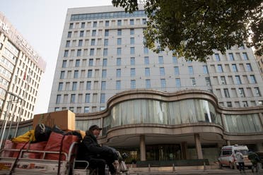 A man drives past the hotel where members of a World Health Organisation (WHO) team are quarantined in Wuhan. (Reuters)