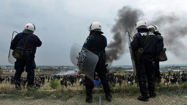 Greek riot police officers stand outside of a refugee camp in Diavata, a west suburb of Thessaloniki. (File photo: AFP)